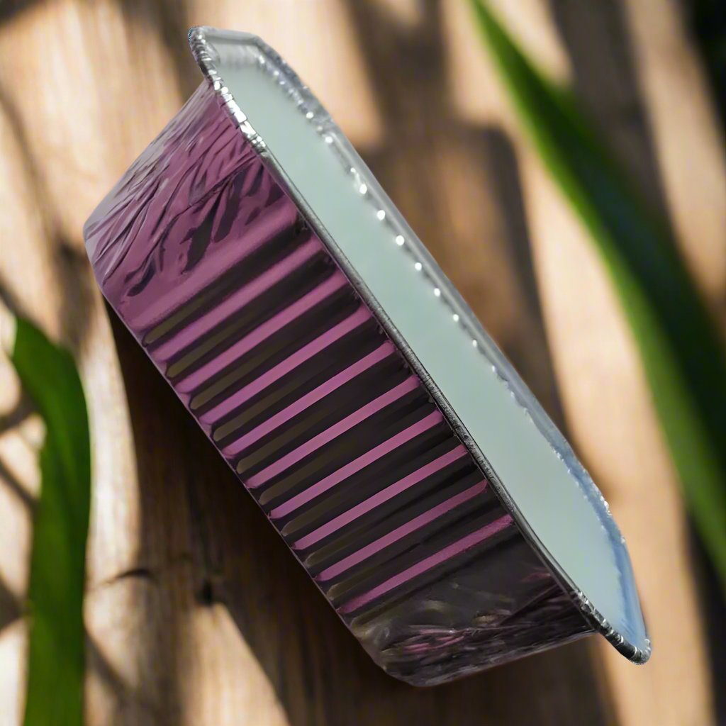 Daisy & Spring Meadows artisan wax melt loaf with a sleek purple exterior and smooth surface against a natural background.