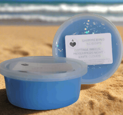 Shimmering blue scoopable wax melts on a sandy beach with ocean waves in the background, evoking coastal tranquility.